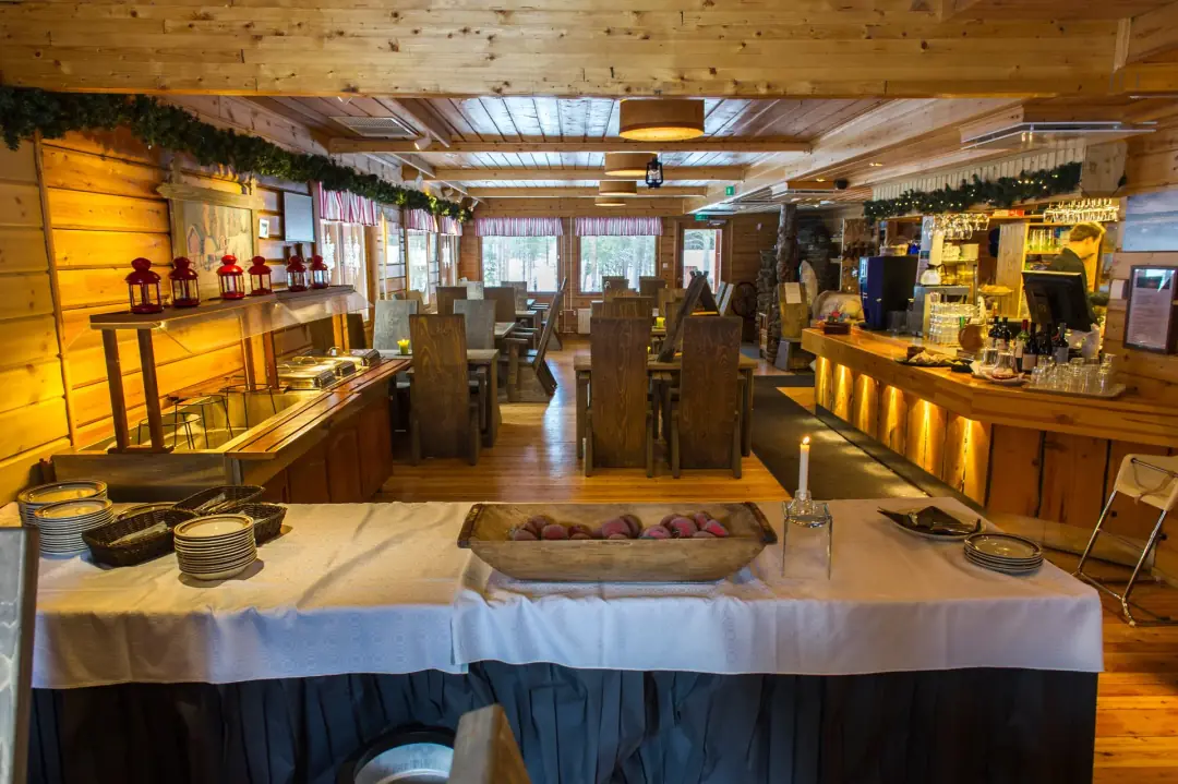 Resort restaurant with cosy wooden interior and dining tables