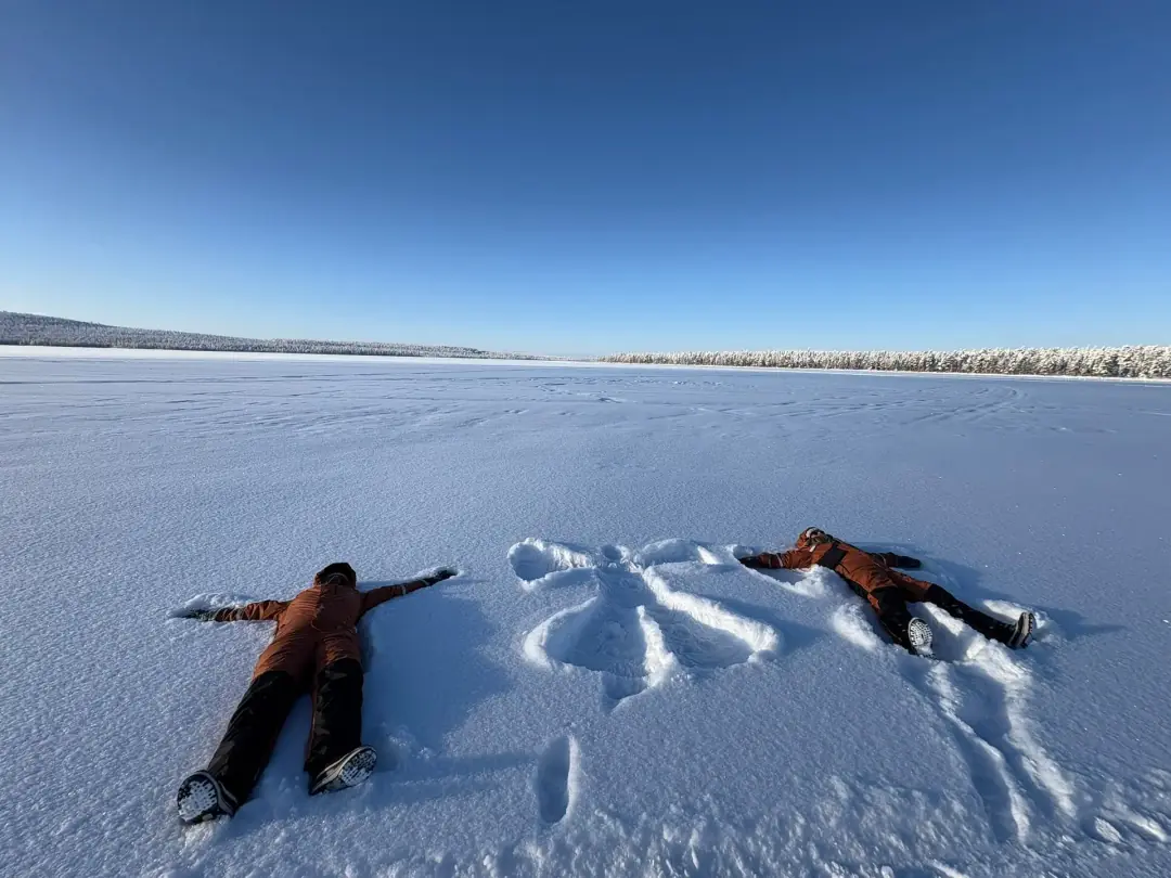 Making snow angels on frozen lake